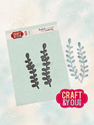 Two black leafy die-cut shapes placed on a light mint instruction card, with Craft & You Dies branding visible and a teal fern cut-out nearby.